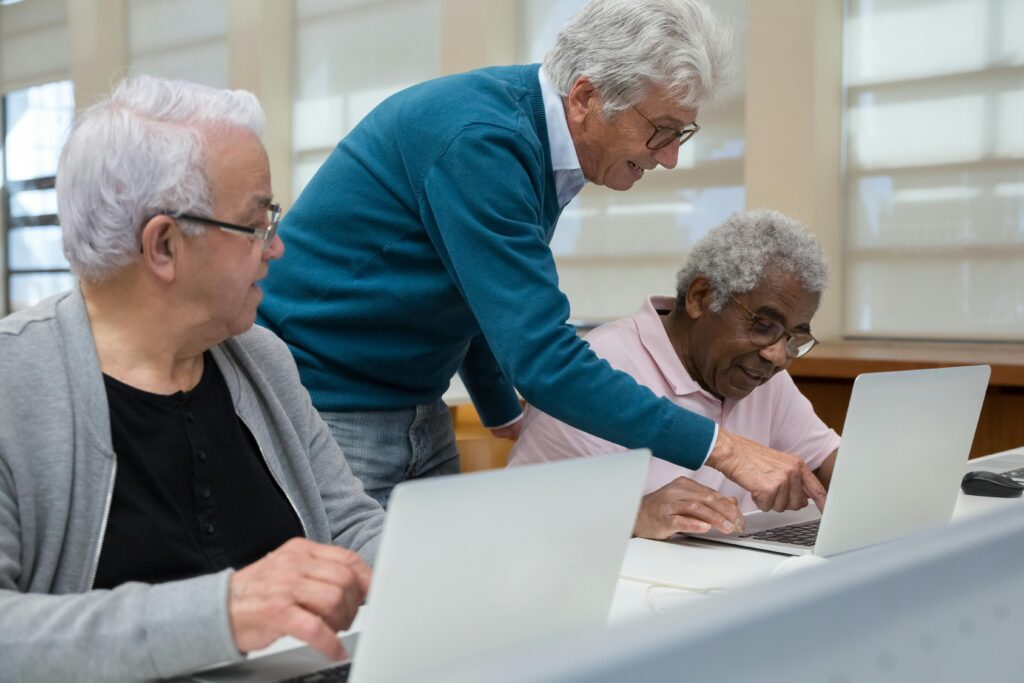 3 men working at a computer.