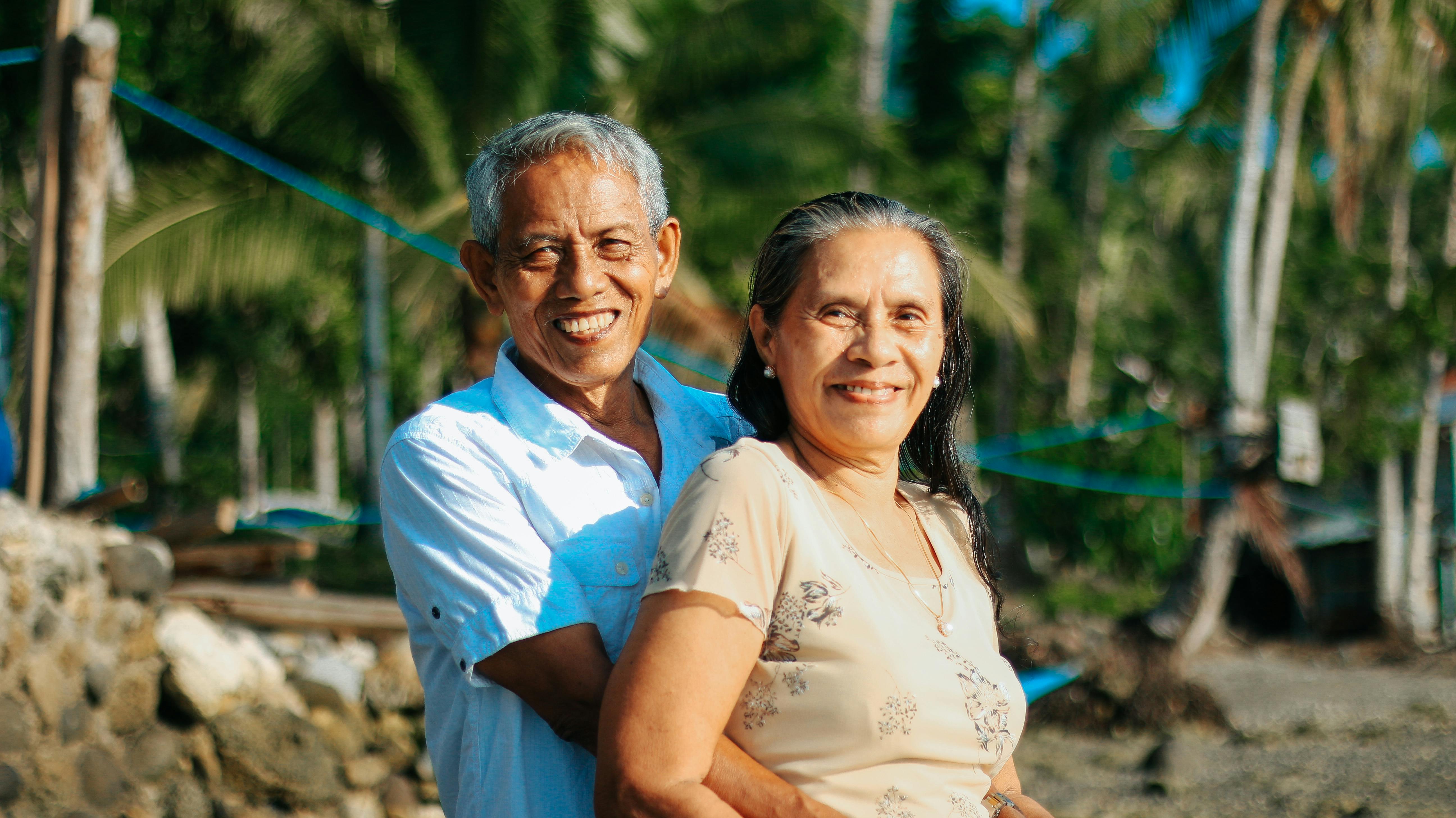 Man standing behind woman in nice embrace, both smiling