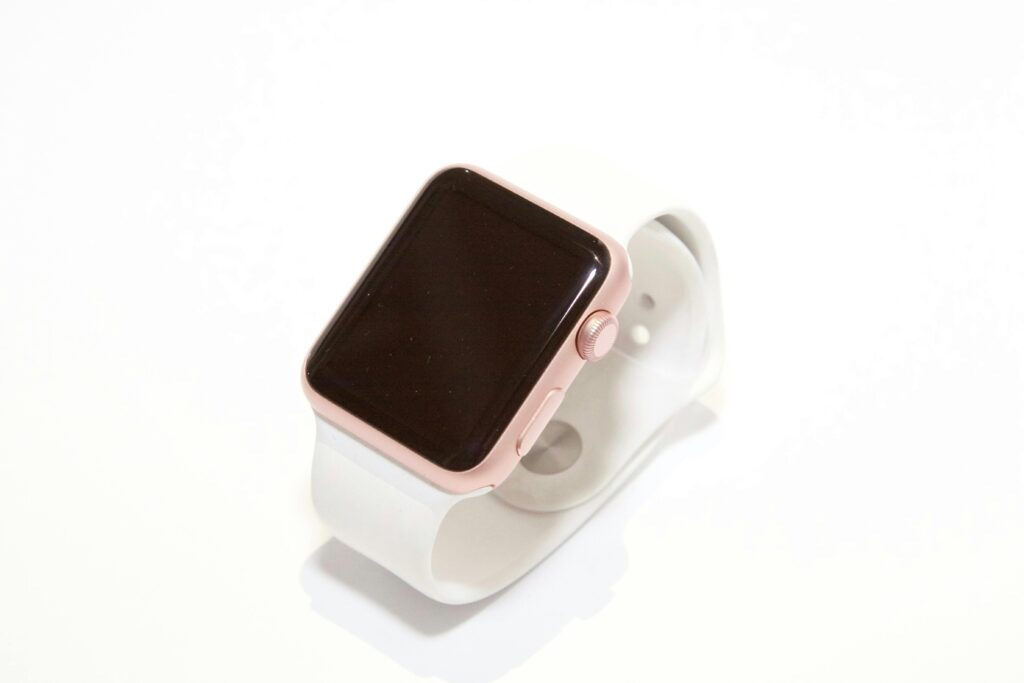 white and pink smart watch on a white background